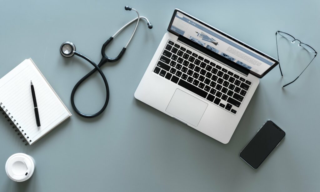 Overview of stethoscope, laptop and medical paraphernalia - Best Practice Cloud Hosting