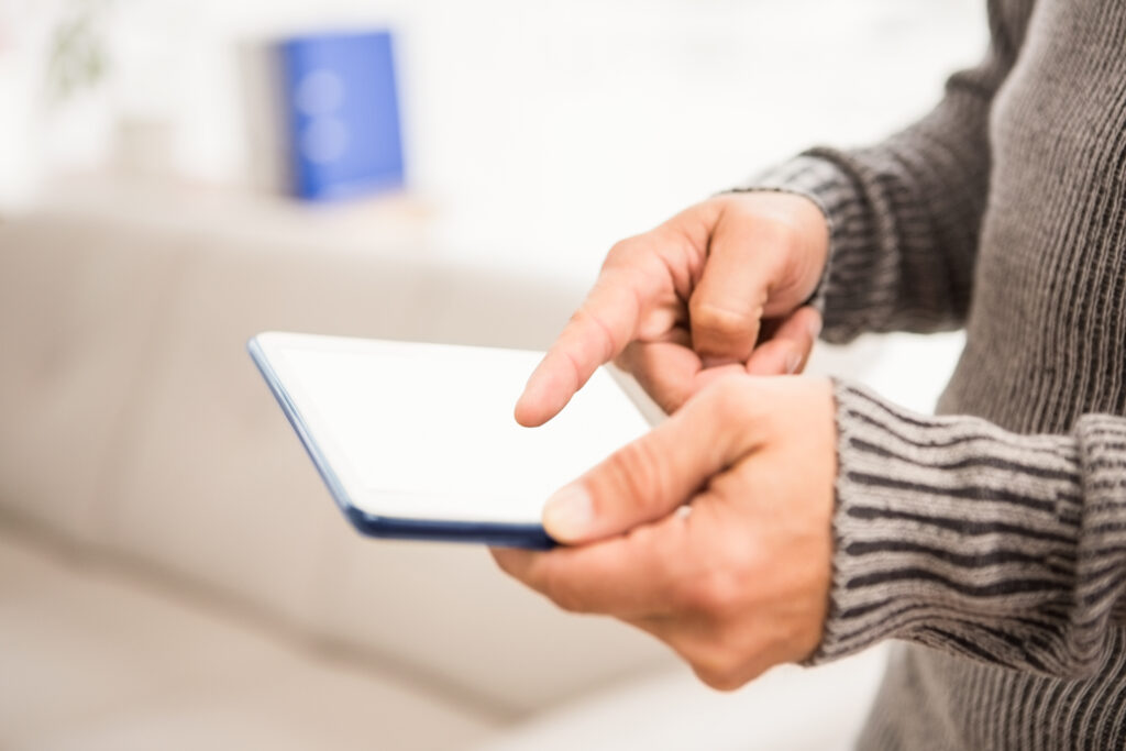 Close up view of hands using tablet in the office